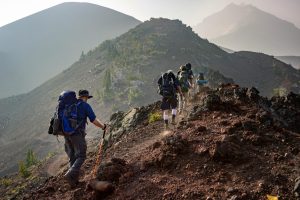 A group of friends hiking on a mountain trail during a walking holiday