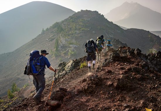 A group of friends hiking on a mountain trail during a walking holiday